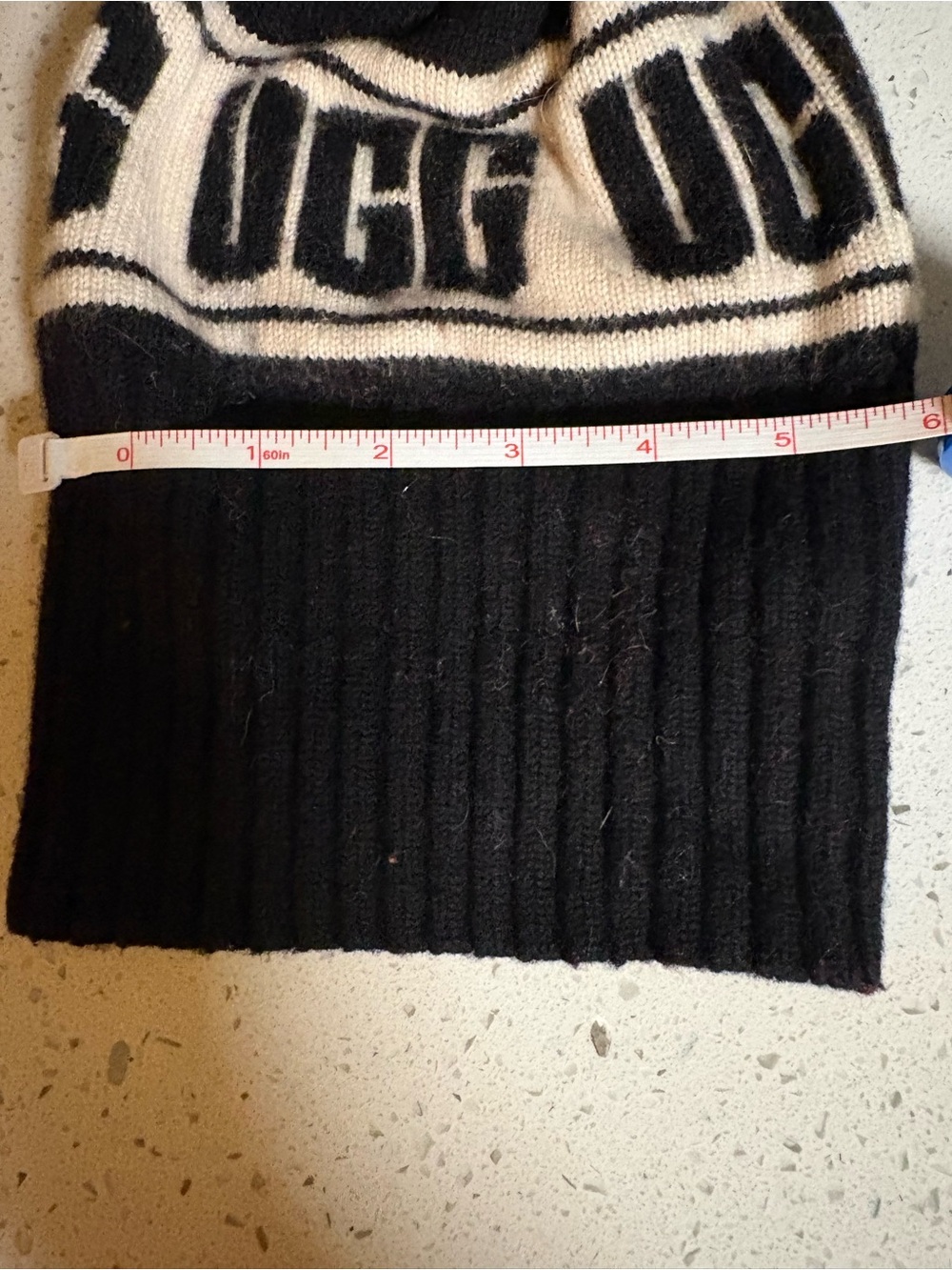 Black and cream knit beanie with 'UGG'
